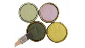 米勒涂料2022年春季颜色的四个油漆罐盖的图像，包括苔藓绿色，黄绿色，玫瑰色，和浅绿色。